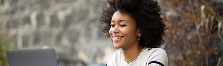 image of young woman looking at laptop computer